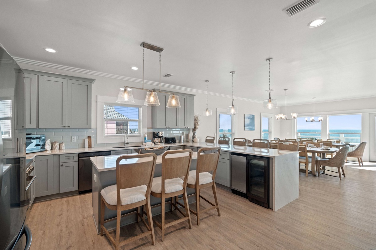 Your spacious kitchen invites culinary adventures with ocean views, granite counters, and a cozy breakfast bar where morning coffee tastes even better.