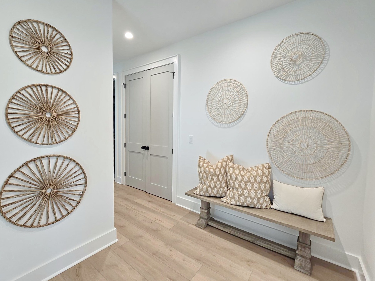 Step into your welcoming entryway where coastal charm meets modern comfort, featuring a stylish bench perfect for settling in.
