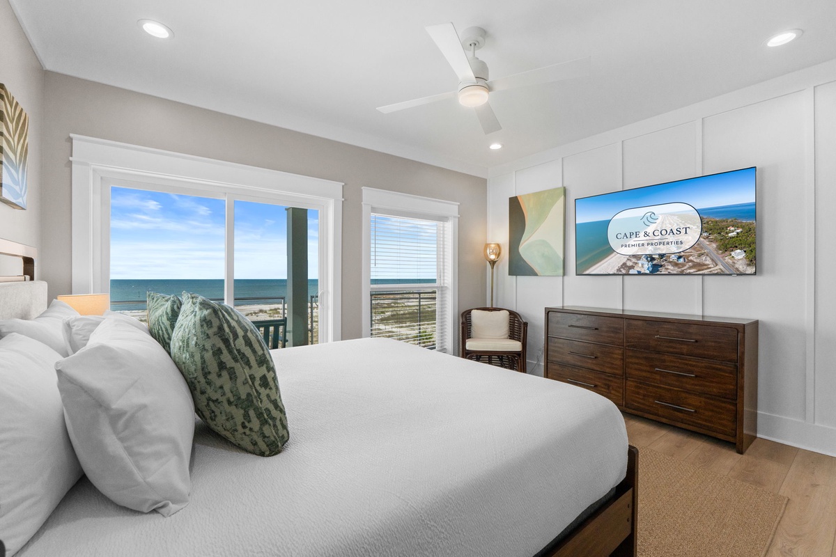 Wake up to stunning ocean views framing your private retreat. This serene bedroom invites you to unwind in coastal elegance, with soft linens and calming decor welcoming you home after days of beachside adventure.