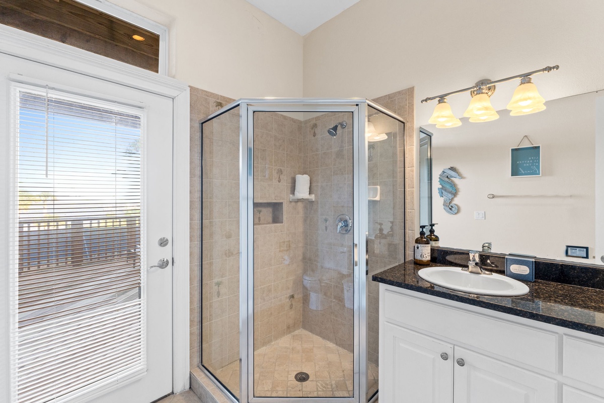 Your ensuite bathroom offers a spacious glass shower, granite vanity, and warm lighting for your daily routines.
