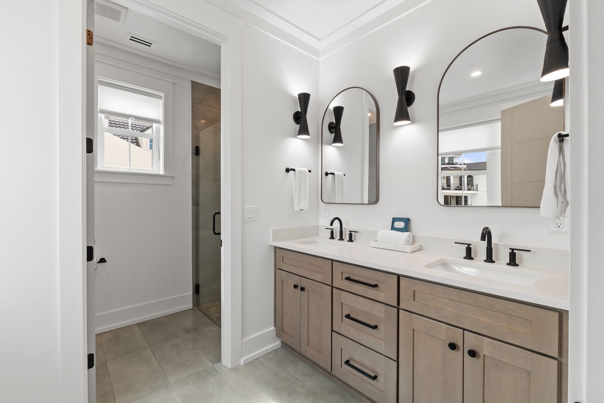 Unwind in your spa-like bathroom with dual vanities and modern fixtures for a luxurious morning routine.