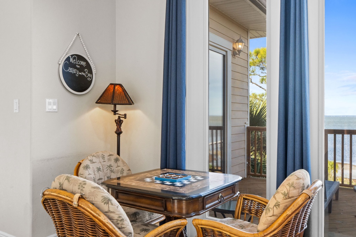 Your cozy seating nook welcomes you with comfortable wicker chairs and ocean breezes flowing through sliding doors.