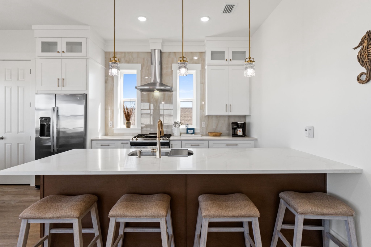 Your gourmet kitchen awaits with pristine counters, professional appliances, and stylish seating for memorable meal prep and casual dining together.