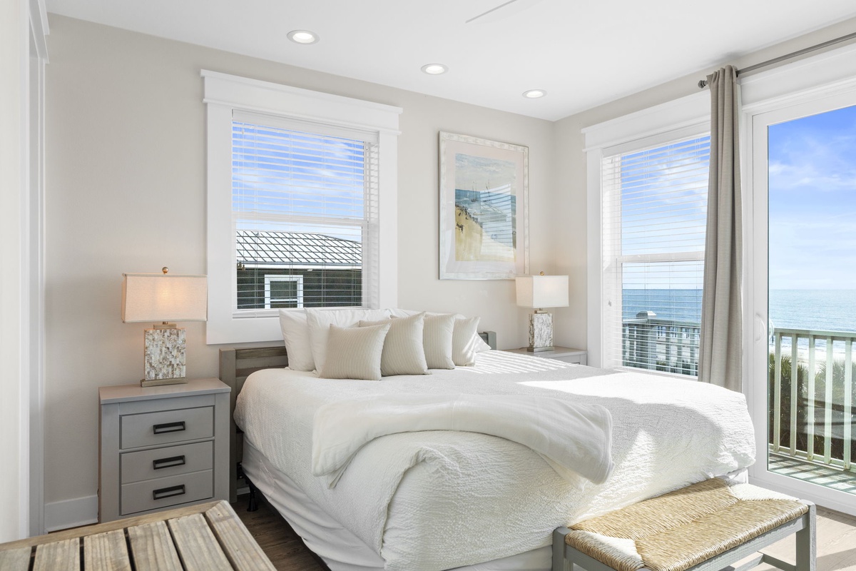 Wake up to stunning ocean views from this bright bedroom with crisp linens and peaceful seaside vibes.