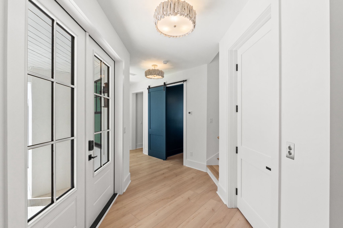Step into your stylish hallway where modern design meets comfort—gleaming hardwood floors and elegant crystal lighting create a welcoming entrance to your home away from home.