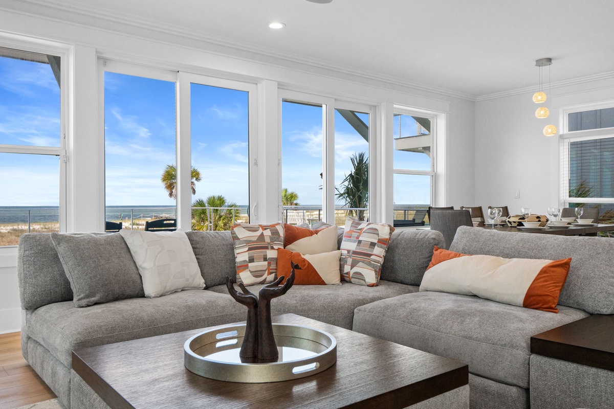 Picture yourself unwinding on plush, oversized sofas while the ocean glistens just beyond the windows. This sun-drenched retreat blends coastal elegance with ultimate comfort, inviting you to relax and soak in stunning sea views.
