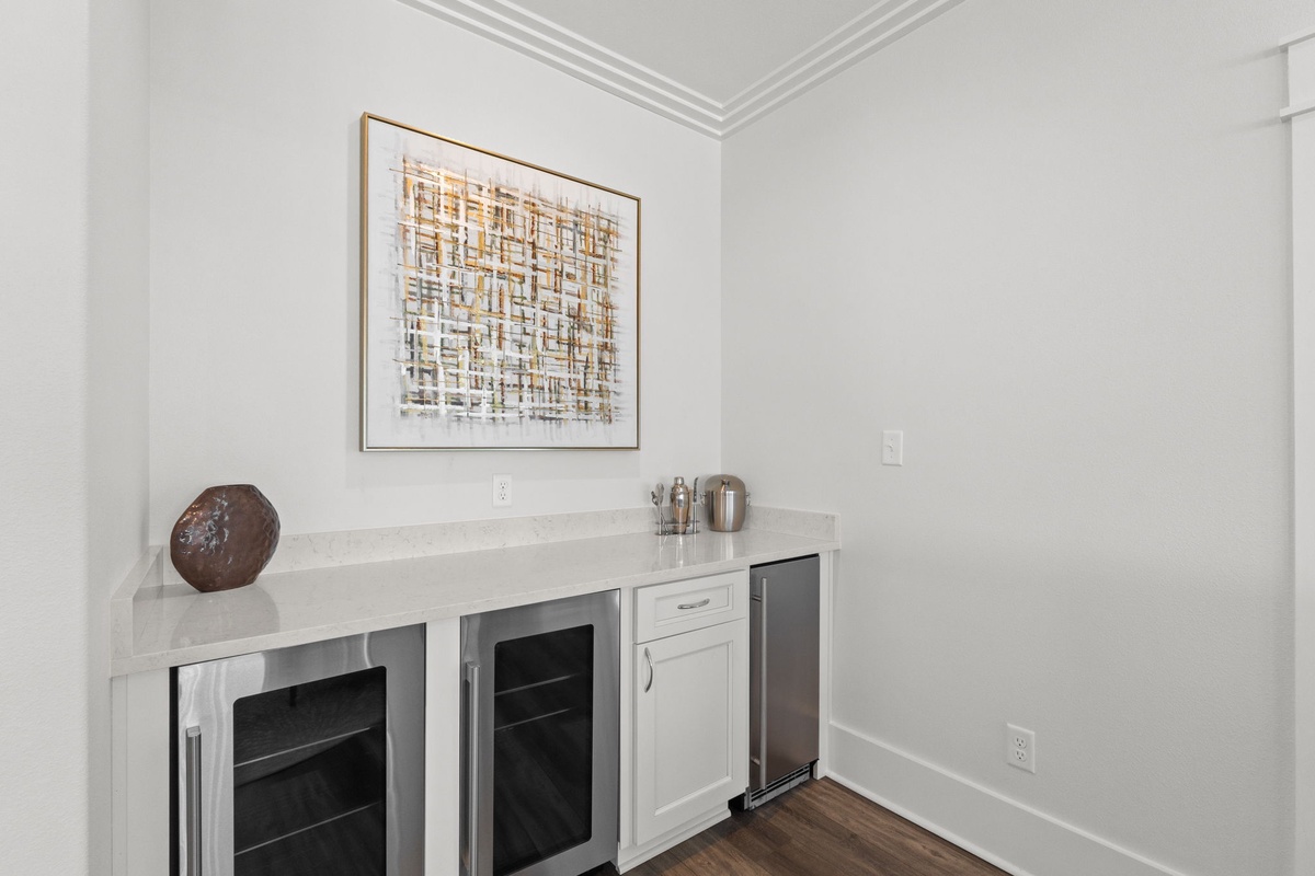 Your private beverage station features elegant countertops and built-in wine coolers, perfect for entertaining guests or unwinding with your favorite drink after a day of adventure.