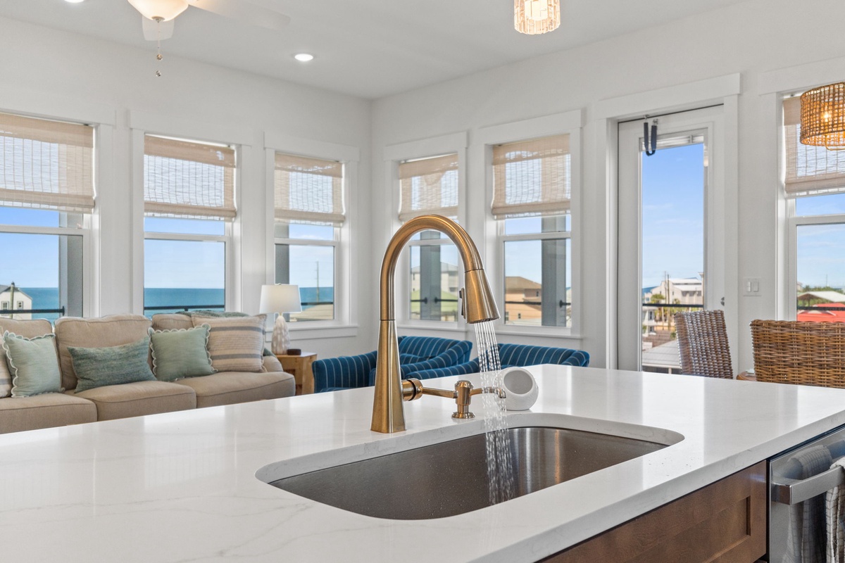 Prepare meals in your elegant kitchen while enjoying stunning ocean views through expansive windows that bathe the space in natural light.