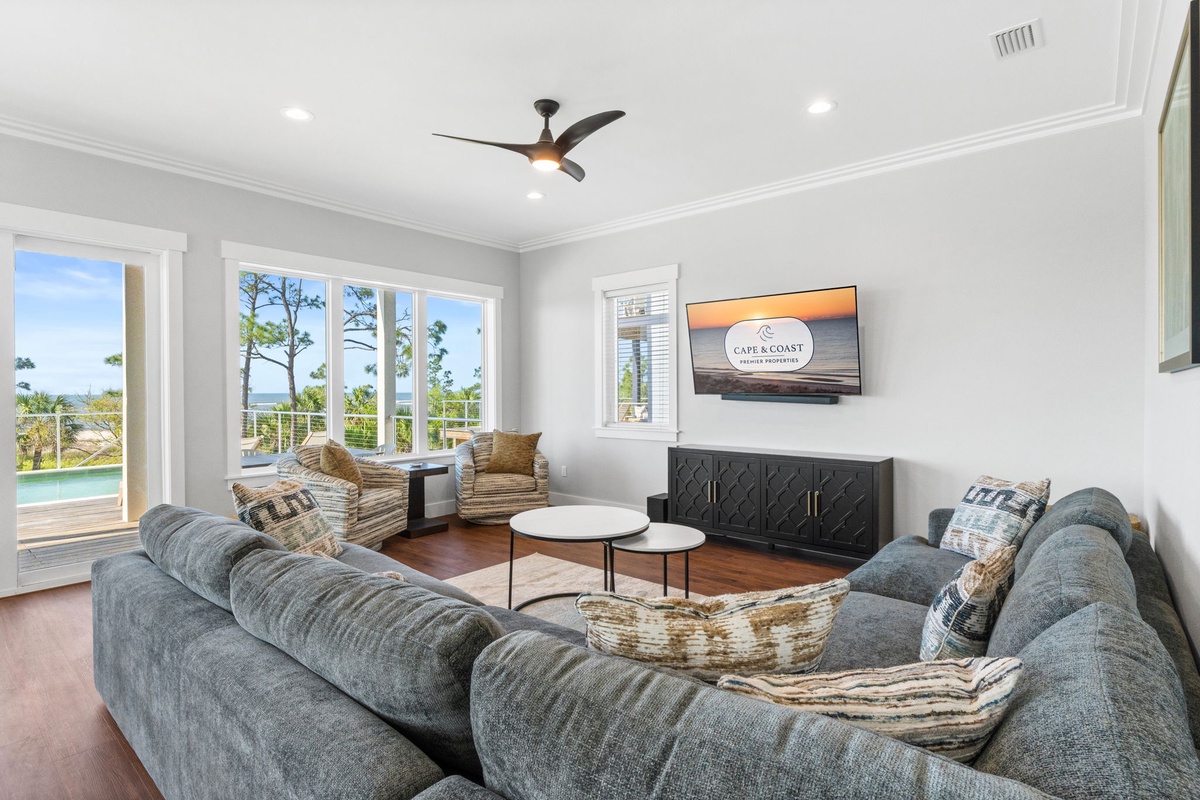 Unwind in your spacious living room with panoramic windows framing stunning water views. Sink into plush seating while ocean breezes cool you.