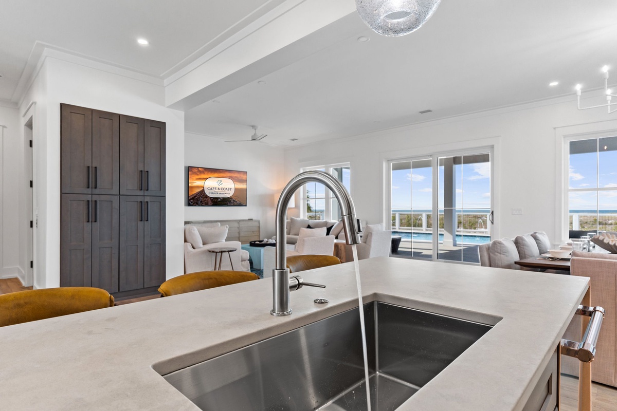 Your gourmet kitchen flows seamlessly into the living space, where ocean breezes meet modern elegance and every meal becomes a celebration.