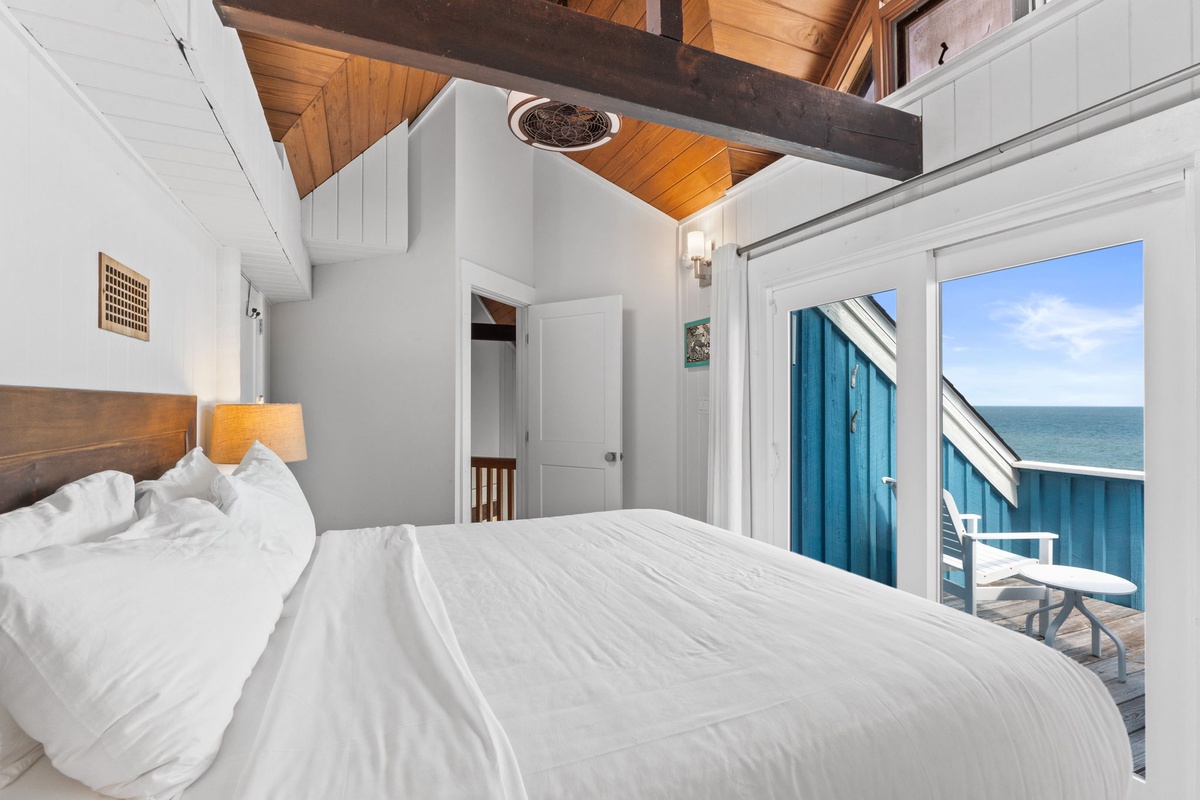 Wake to stunning ocean views and gentle sea breezes in your coastal retreat. Bright, vaulted ceilings and warm wood accents create an airy, inviting space where you can truly unwind.