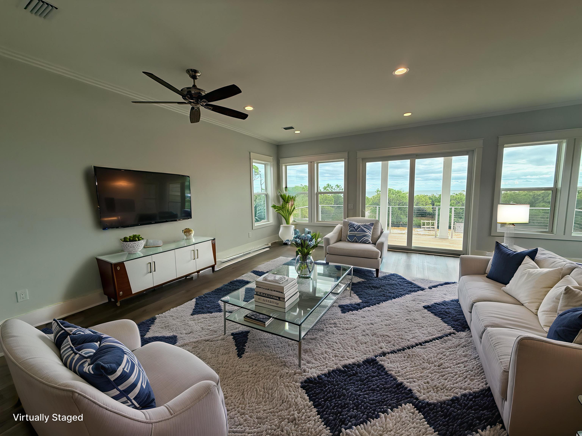 Sink into plush seating while enjoying modern comforts and panoramic views through floor-to-ceiling windows that frame your peaceful retreat.