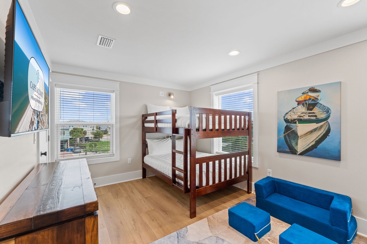 Unwind in this comfortable room featuring a bunk bed, flat-screen TV, and soft nautical touches. Two windows welcome natural light, and you'll appreciate the cozy seating to relax after a day of adventure.