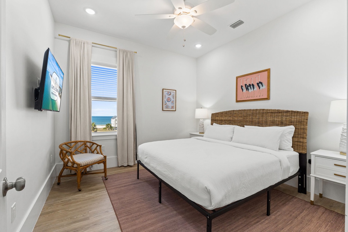 Your coastal bedroom retreat features crisp linens and stunning ocean views through your private window.