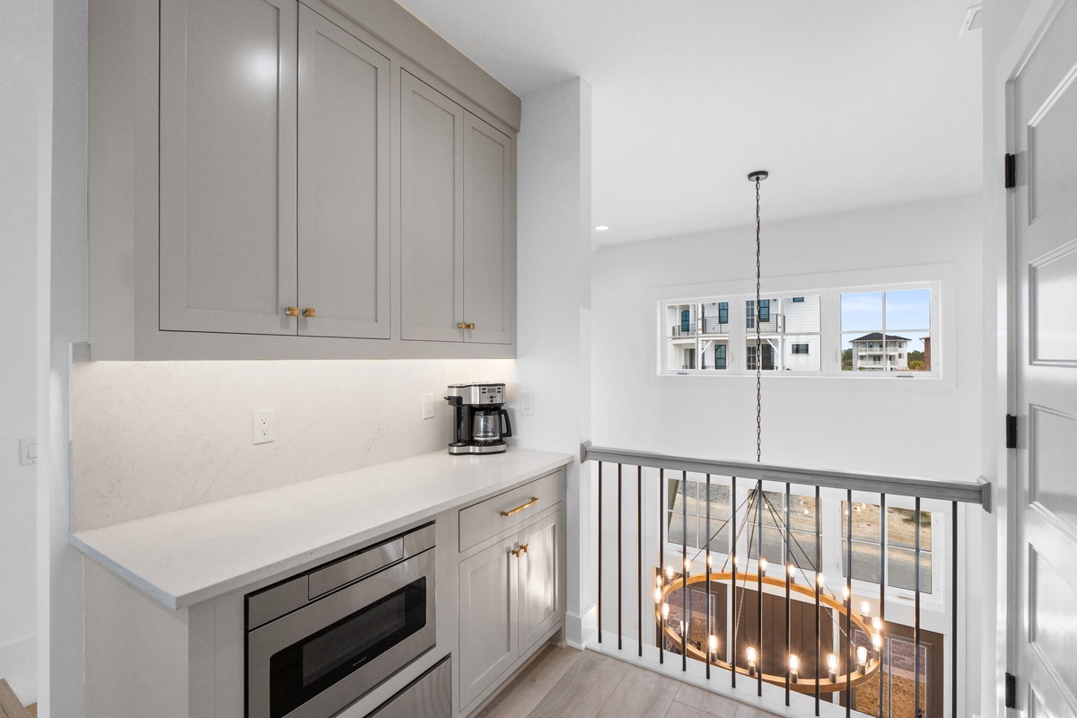 Your elegant kitchenette features marble counters, premium appliances, and coffee facilities for effortless morning prep.