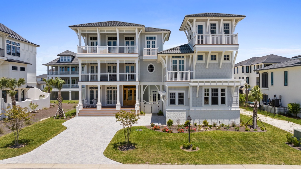 Elegant coastal architecture welcomes guests to this spacious vacation retreat, set in a peaceful residential neighborhood near the beach with easy parking access.