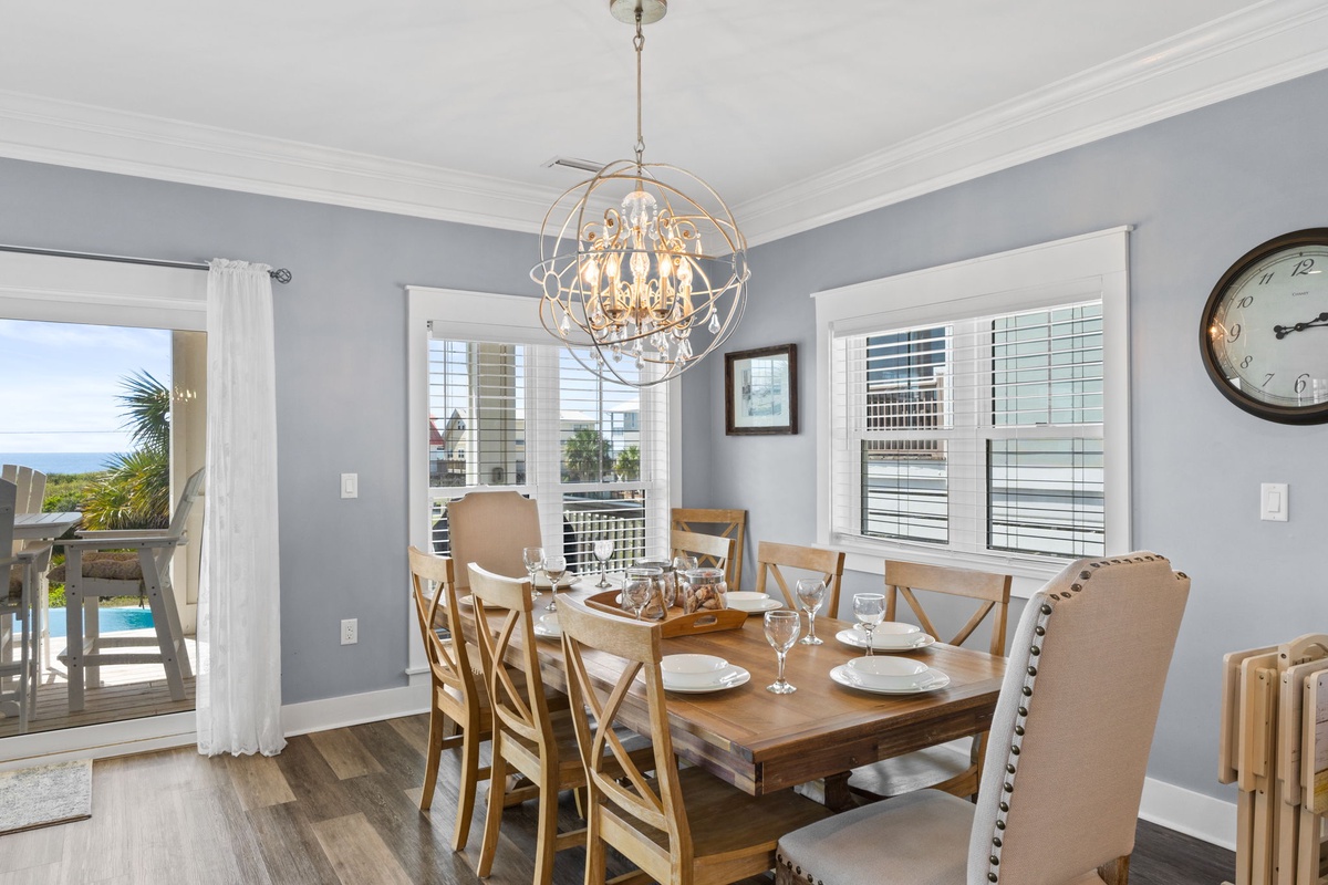 Gather around your elegant dining table beneath a stunning chandelier, where memorable meals unfold with city views through pristine windows.