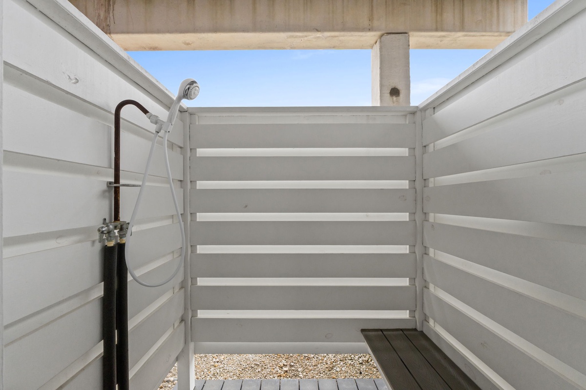 Your private outdoor shower offers a refreshing open-air bathing experience under the blue sky.