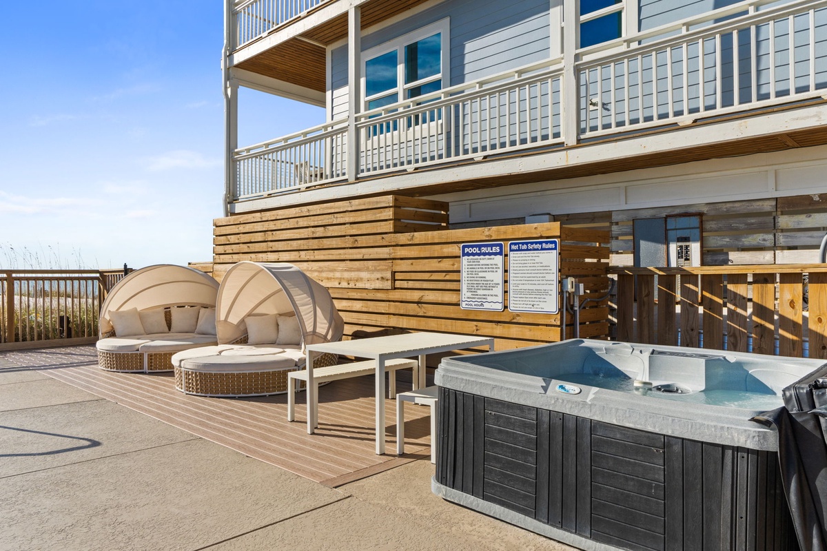 Soak in your private hot tub while lounging on comfortable deck chairs under the sunny sky.