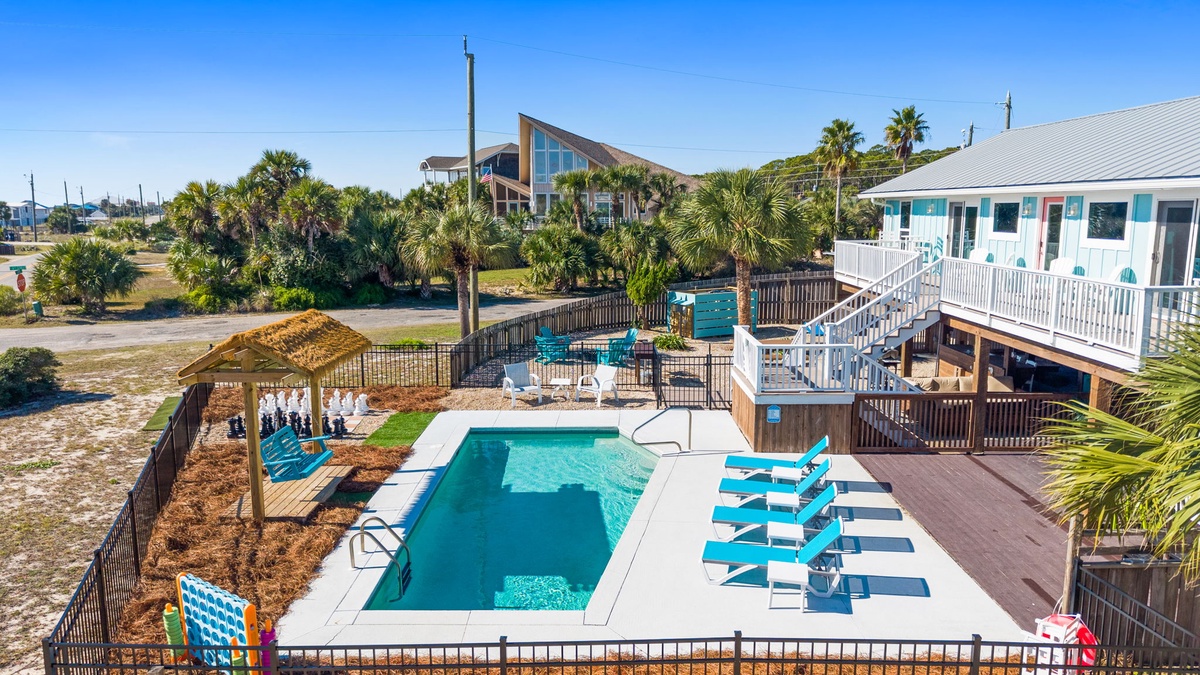 The private pool area offers ample lounge seating and shaded spots for relaxing between beach days.