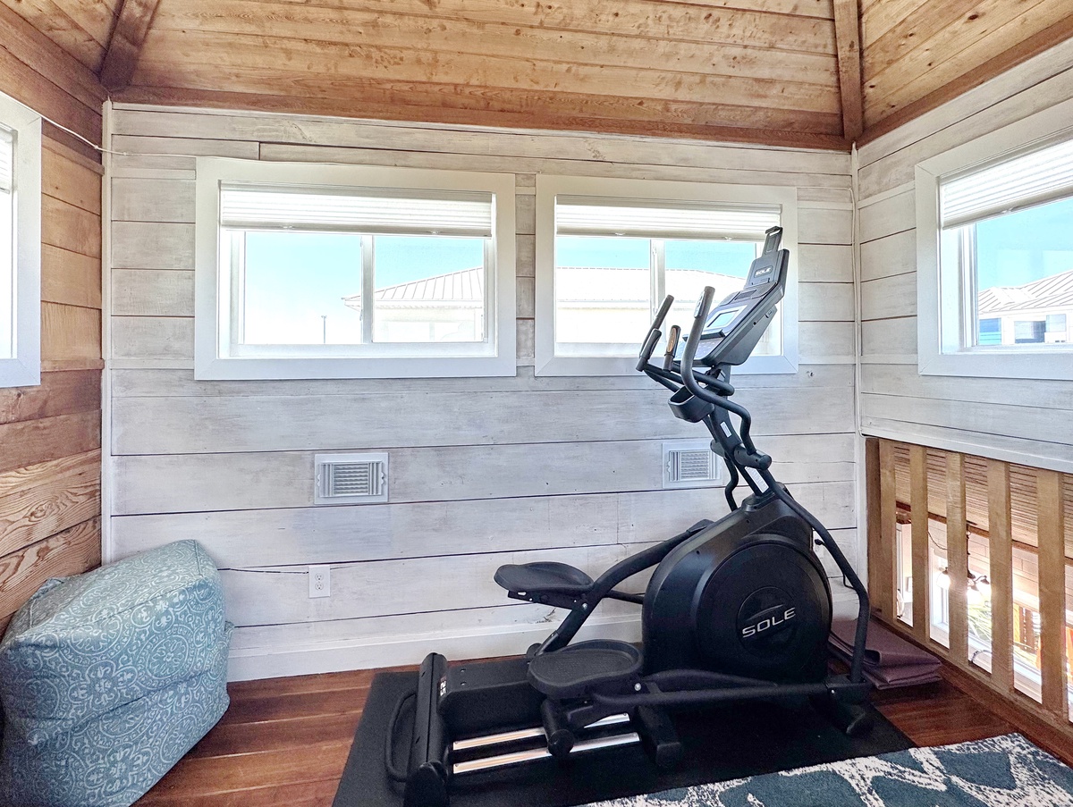Stay active during your getaway with this well-lit fitness area featuring quality equipment and natural wood charm.
