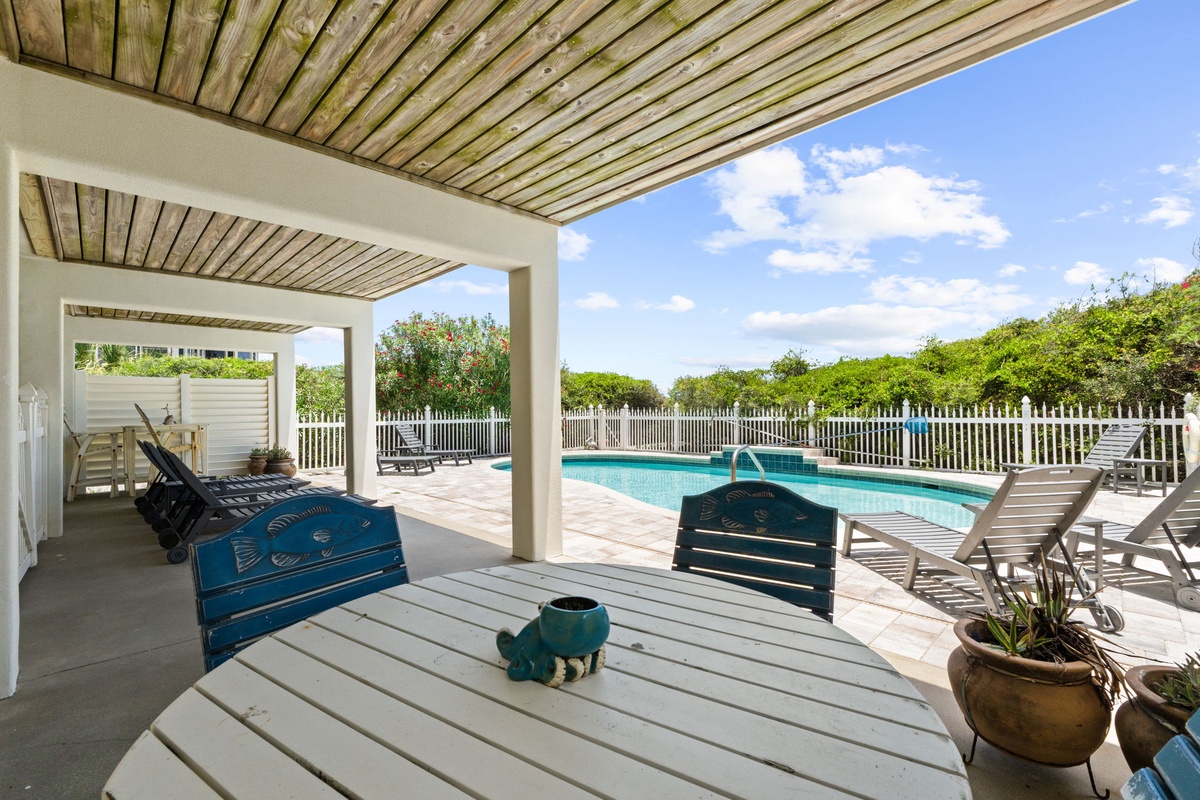 Stretch out on your private deck overlooking the sparkling pool, where sunshine, leafy surroundings, and coastal breezes create your perfect escape.