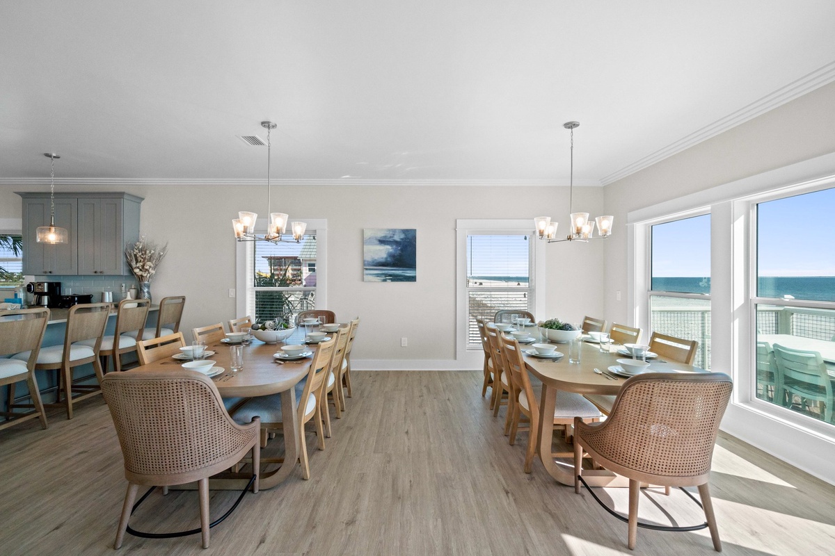 Your spacious dining area offers dual tables perfect for family meals while you enjoy breathtaking ocean views through floor-to-ceiling windows.
