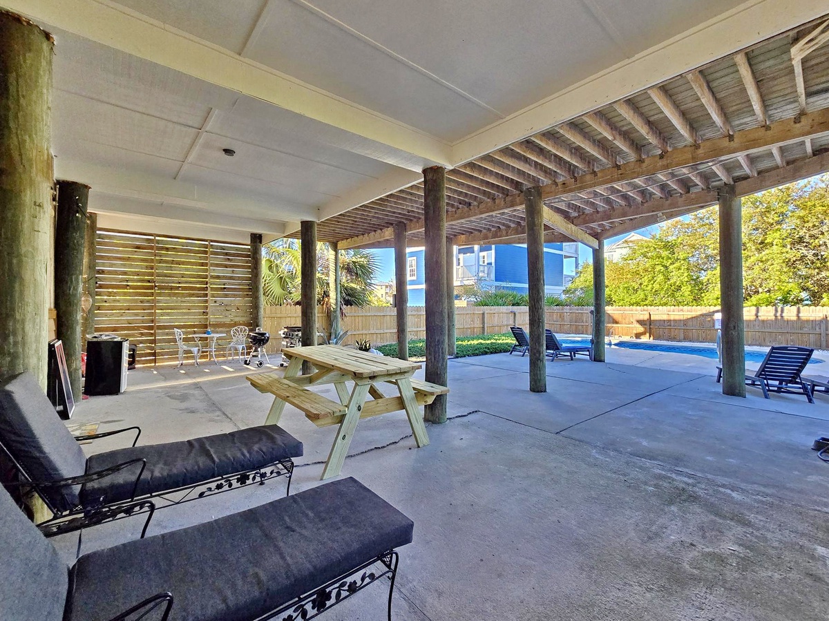 Relax under your covered patio with BBQ, picnic table, and pool views—perfect for outdoor dining and entertainment.