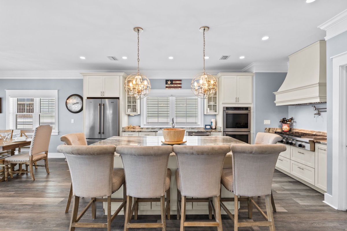 Your gourmet kitchen invites culinary adventures with gleaming countertops, premium appliances, and elegant pendant lighting creating the perfect gathering space.