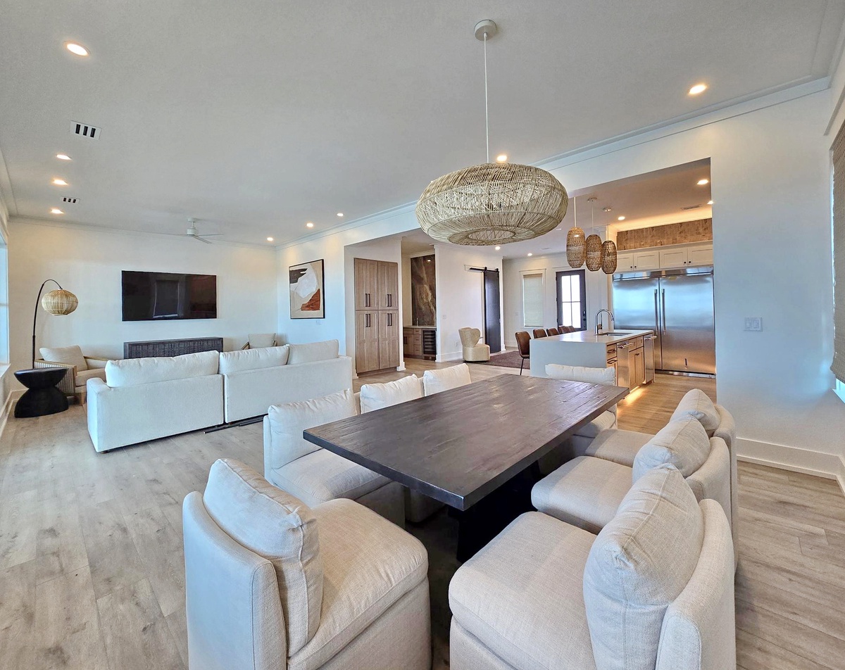 Unwind in your spacious open-concept haven where natural textures and modern elegance create the perfect gathering space for memorable meals.