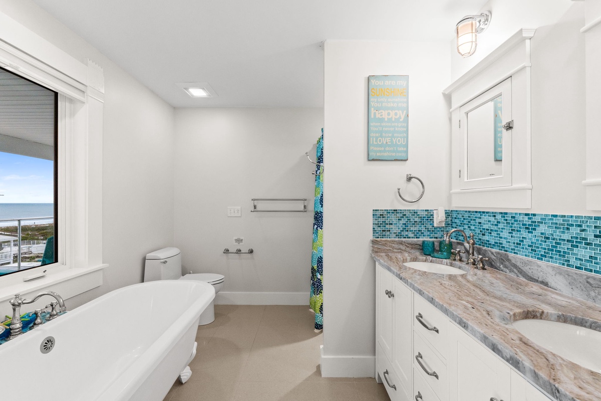 Unwind in your spa-like bathroom with stunning marble countertops, vibrant turquoise tiles, and a soaking tub perfect for relaxation.