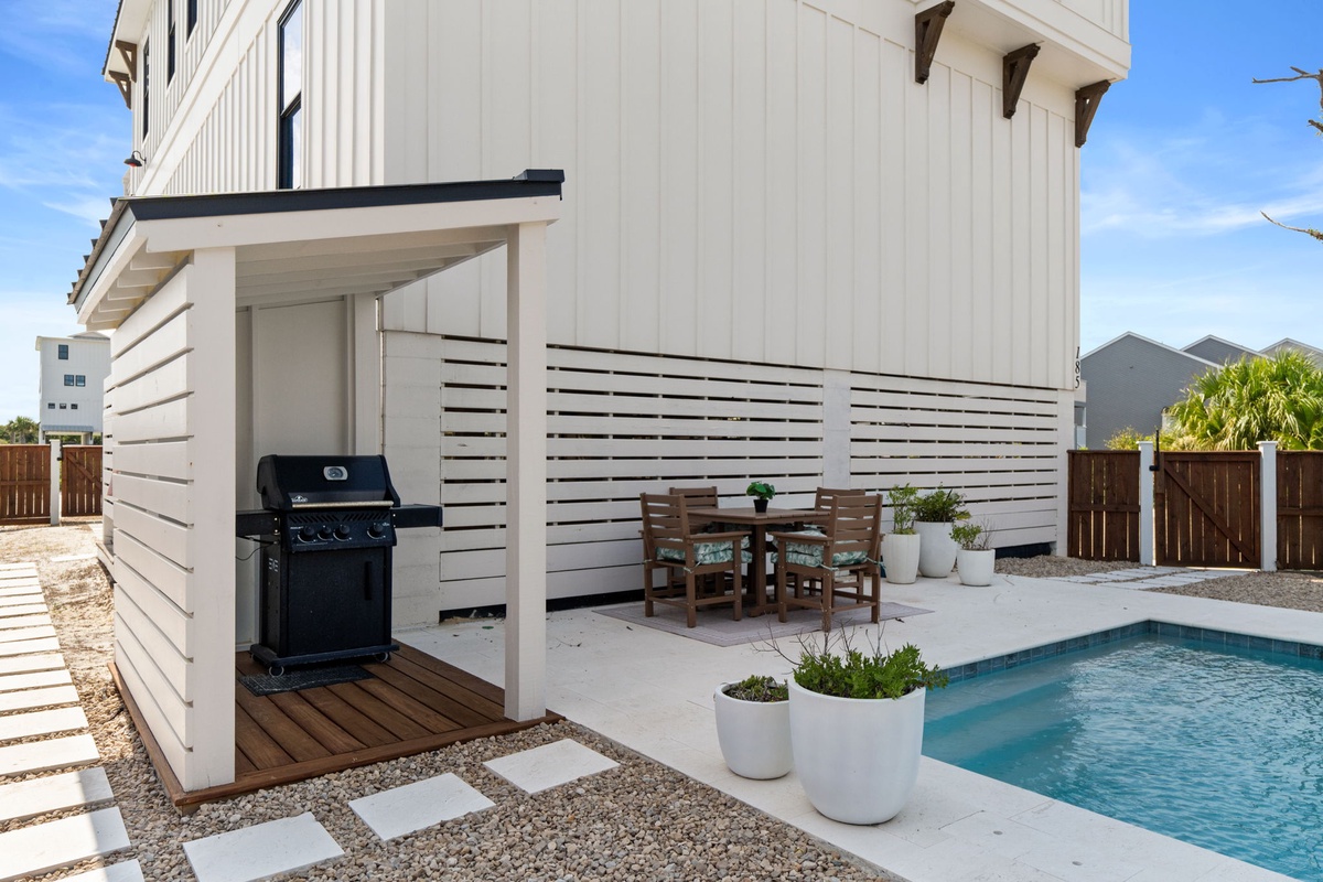 Modern outdoor patio showcases a private pool, BBQ area, and poolside dining, perfect for sunny afternoons and evening gatherings with mountain views.