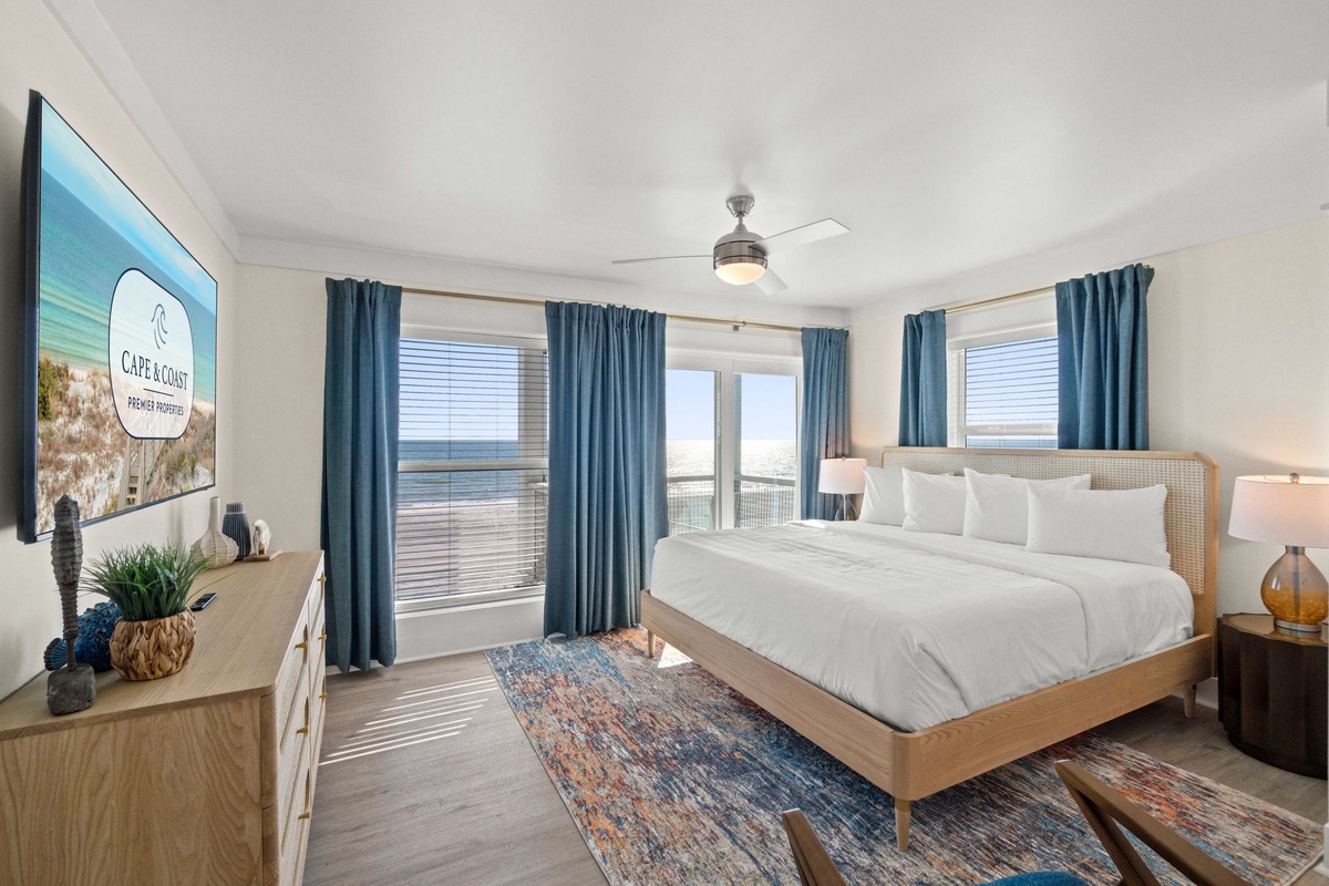 Wake up to stunning views in this bright coastal bedroom with crisp linens and modern comfort.