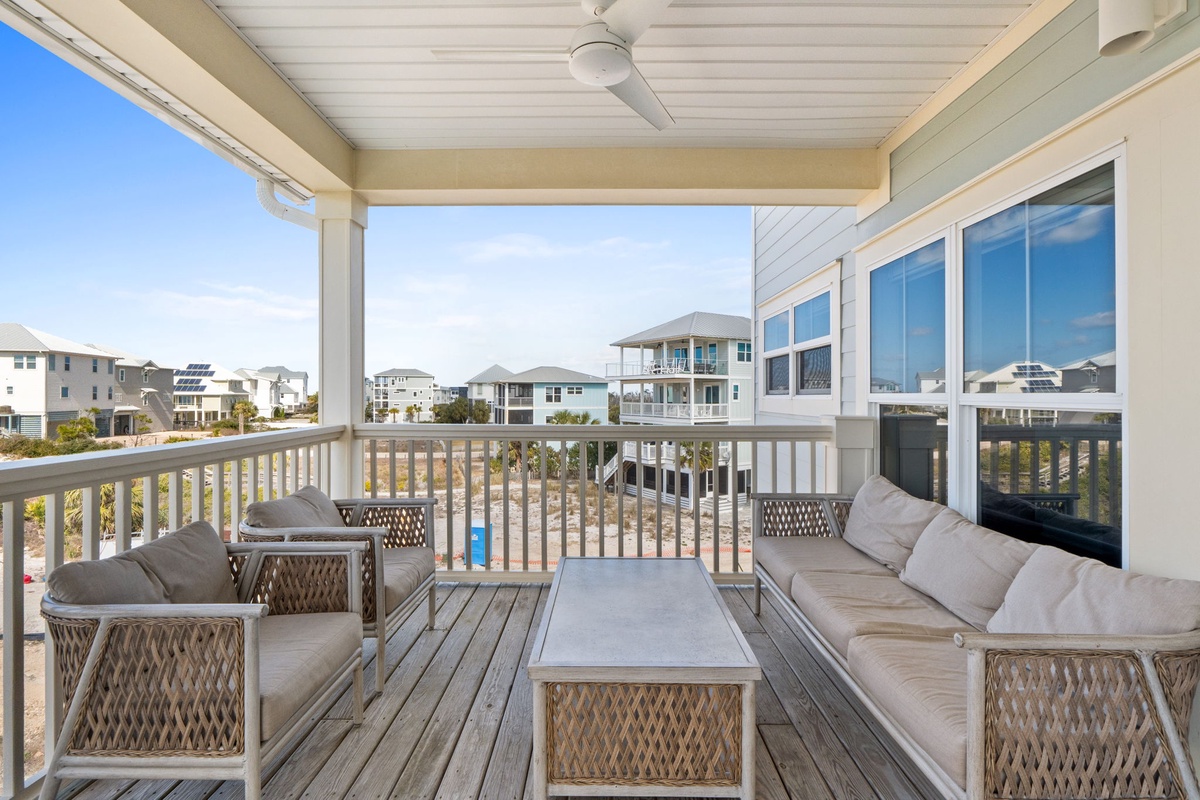 Unwind on your private covered deck with plush seating and sweeping views of coastal homes.