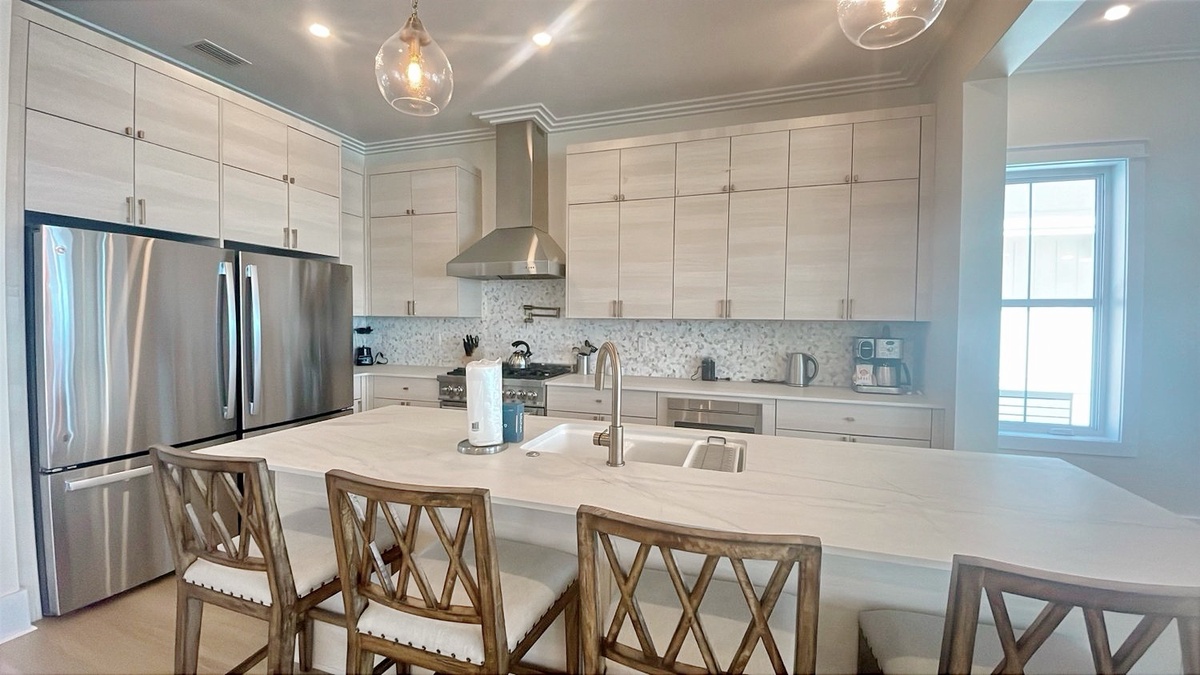 Your spacious, fully equipped kitchen features sleek modern appliances, gleaming countertops, and an elegant island—perfect for preparing meals and gathering with loved ones in effortless style and comfort.