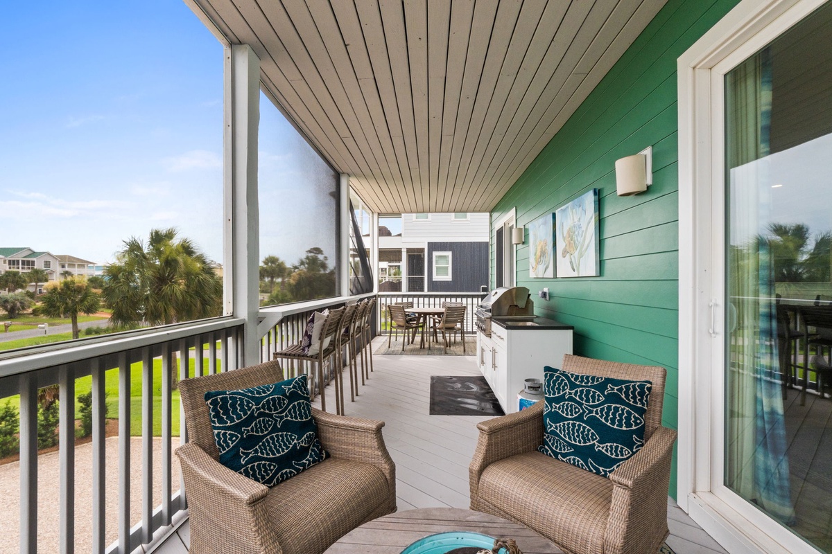 Settle into plush wicker chairs on your covered porch, sipping morning coffee as you take in peaceful neighborhood views surrounded by swaying palms and coastal charm.