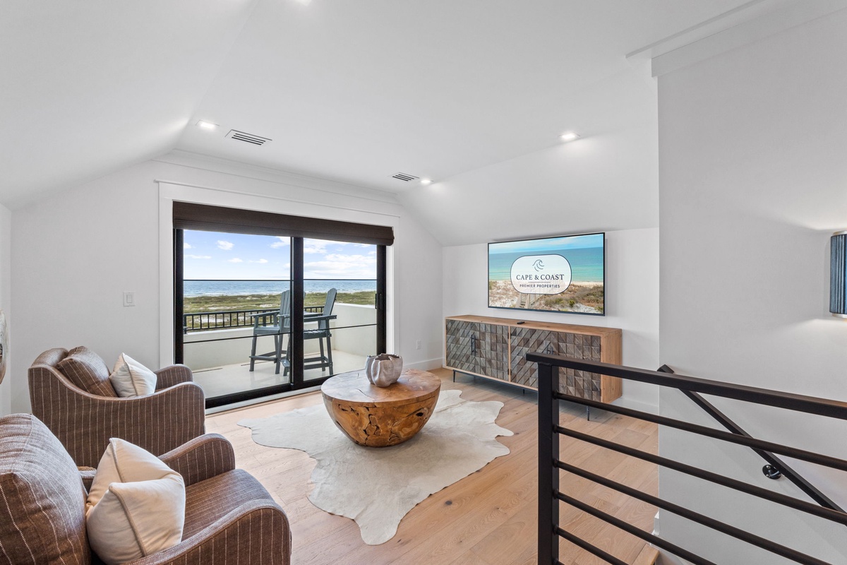 Unwind in your upstairs retreat with a stunning coastal view through sliding glass doors that open to the balcony. Natural light and ocean breezes invite you to relax.