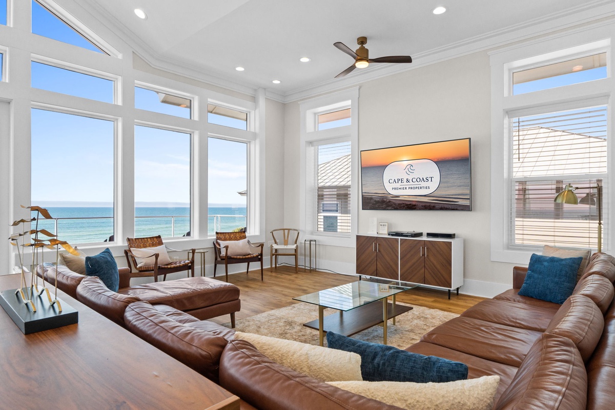 Relax in your bright living room with panoramic ocean views and comfortable leather seating perfect for unwinding.