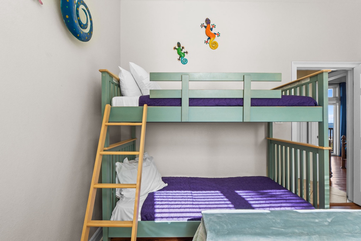Your kids will love this cheerful bunk bed with whimsical gecko decorations and cozy purple linens in their own special room.