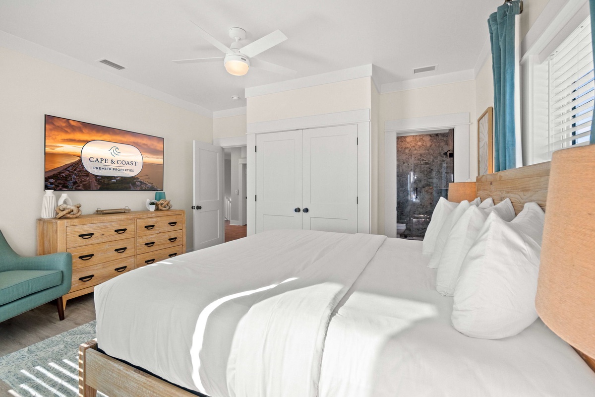 Drift off to sleep in your serene bedroom, where coastal breezes from the ceiling fan and plush linens create the perfect retreat.