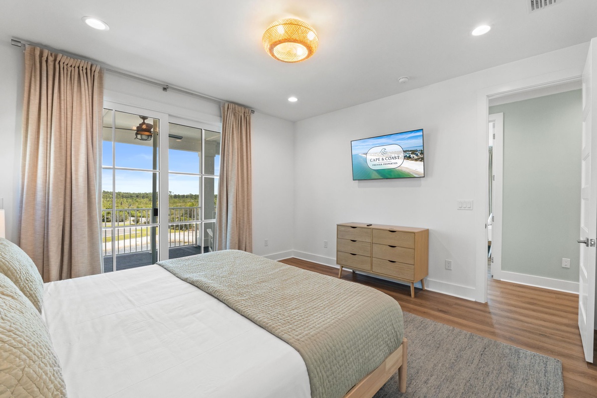 Your serene bedroom retreat features a plush bed, stylish furnishings, private balcony access, and warm lighting to help you unwind in comfort.