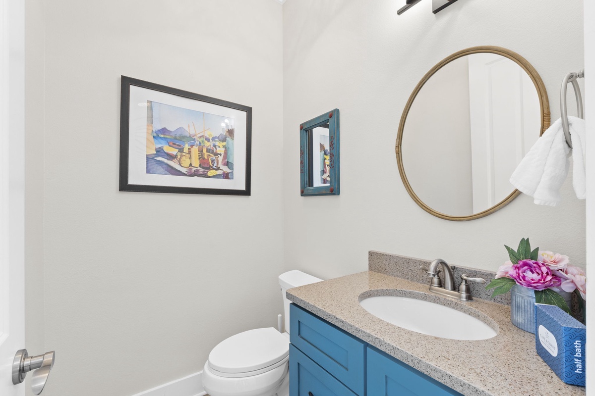 Your stylish powder room features a beautiful blue vanity with granite countertop, perfect for freshening up during your stay.