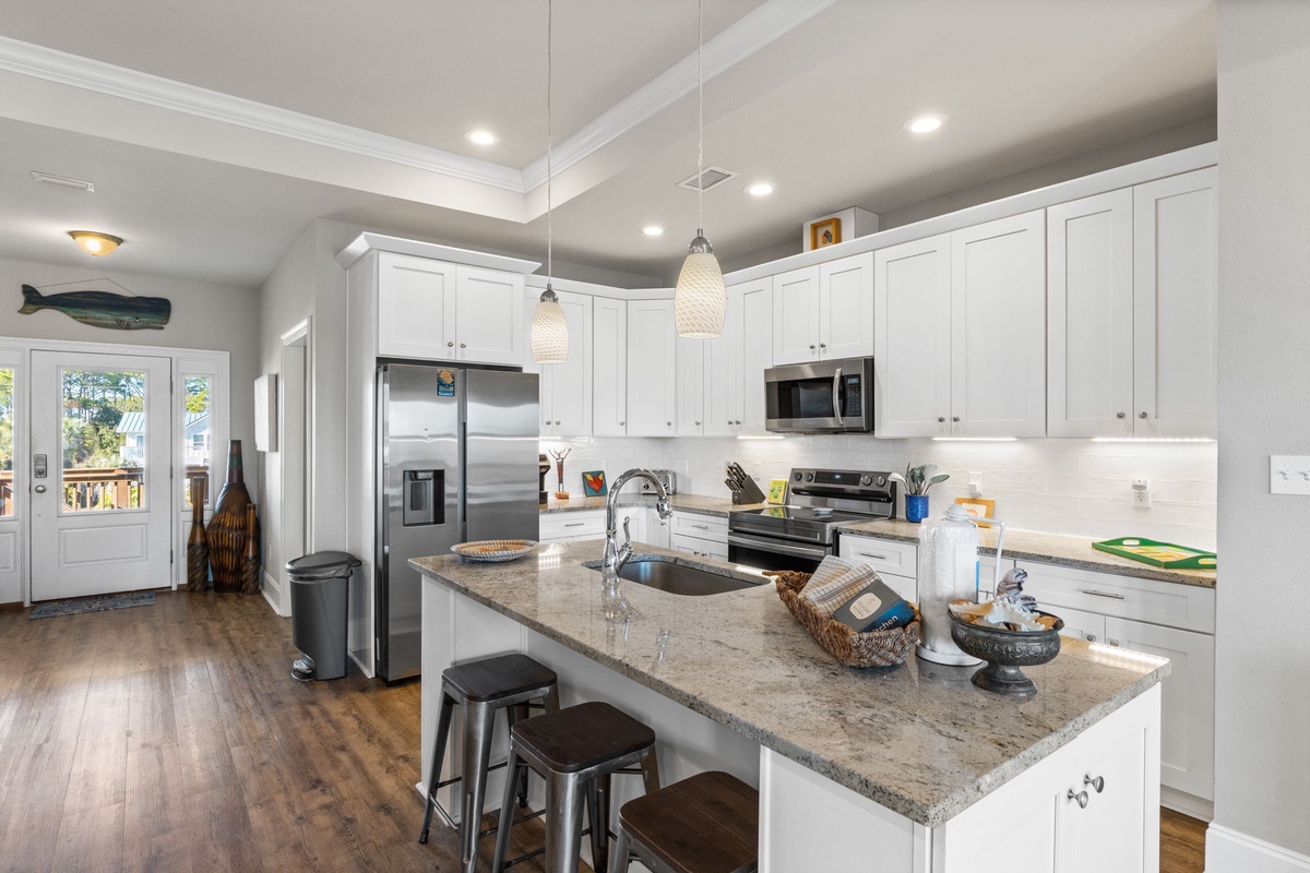 Your spacious kitchen features granite counters, stainless appliances, and an island perfect for morning coffee or meal prep together.