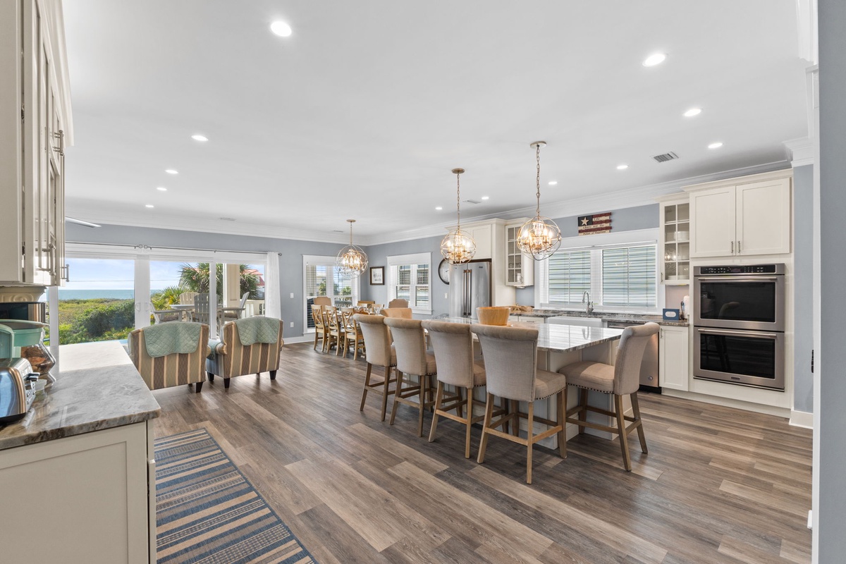Your spacious kitchen flows seamlessly into the dining area, featuring gleaming countertops and elegant pendant lighting for memorable meals together.