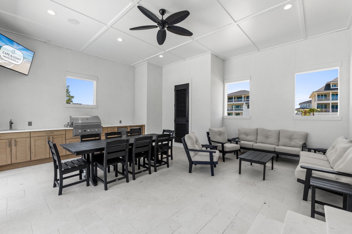Gather in a modern indoor-outdoor lounge with a full kitchen and comfortable seating—perfect for hosting meals or relaxing together after a day of coastal adventures.