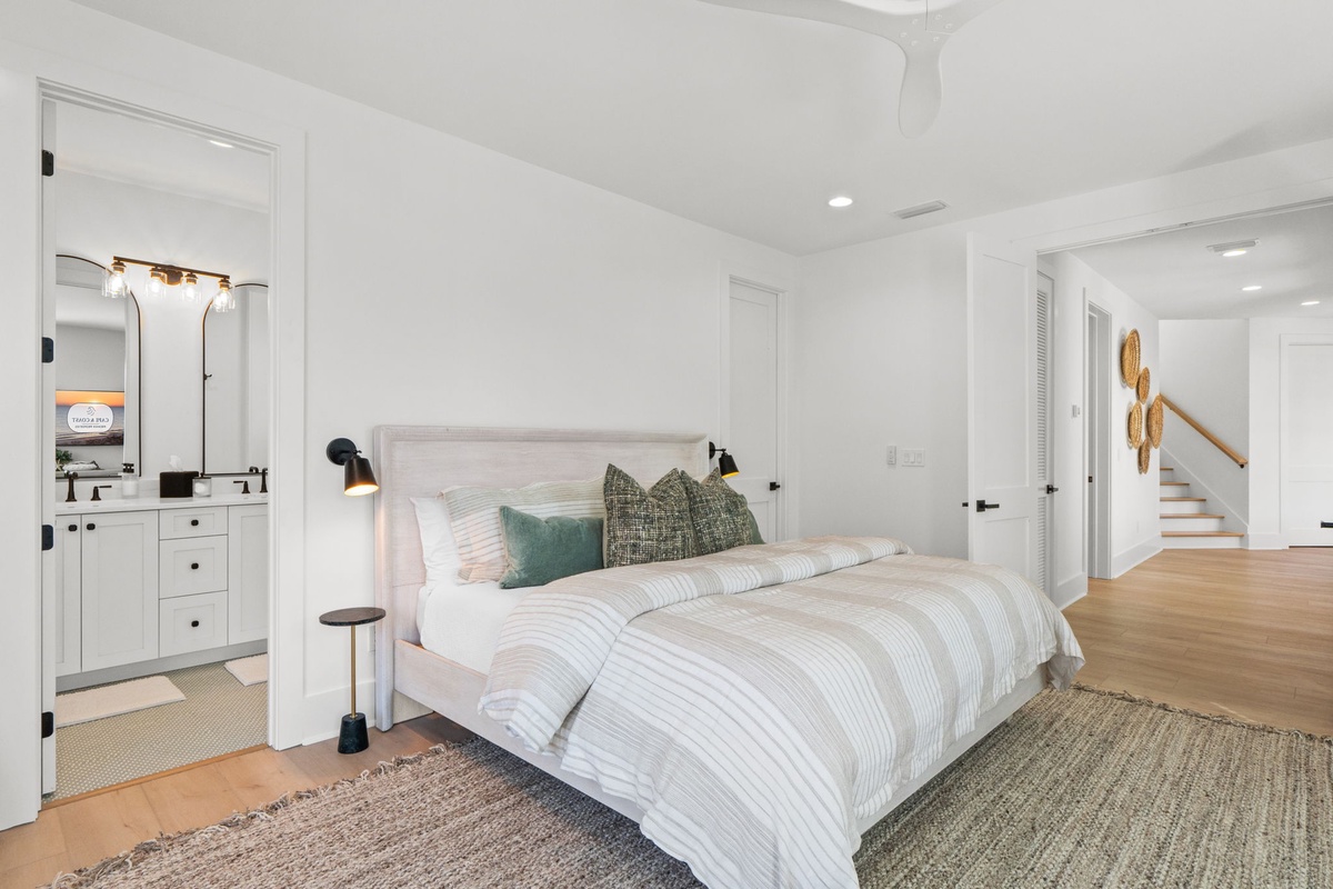 Drift off to sleep in your serene master suite with crisp linens, soft lighting, and peaceful white tones creating the perfect retreat.