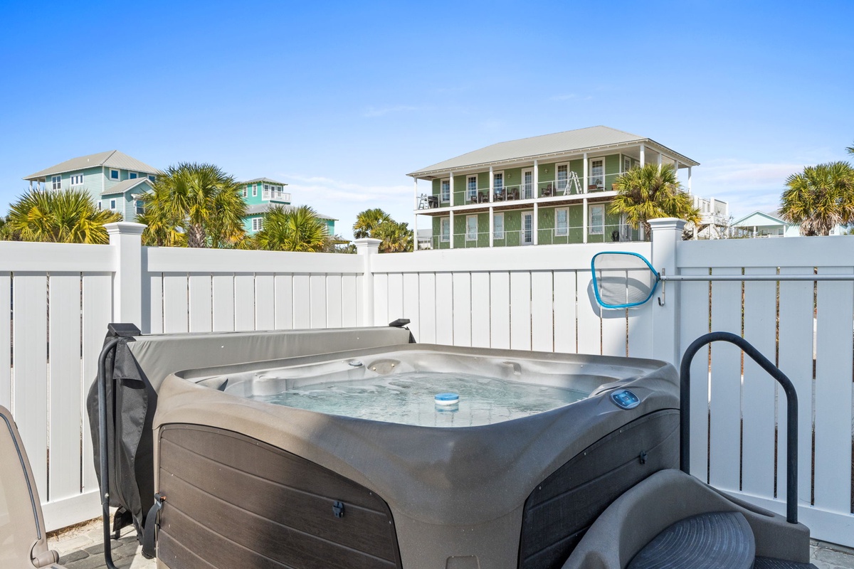 Soak in your private hot tub surrounded by coastal charm and swaying palms, perfect for unwinding after beach days.