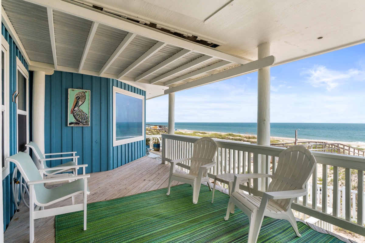 Your covered beachfront deck opens to stunning ocean views, with comfortable seating perfect for morning coffee or sunset watching just steps from the sand.