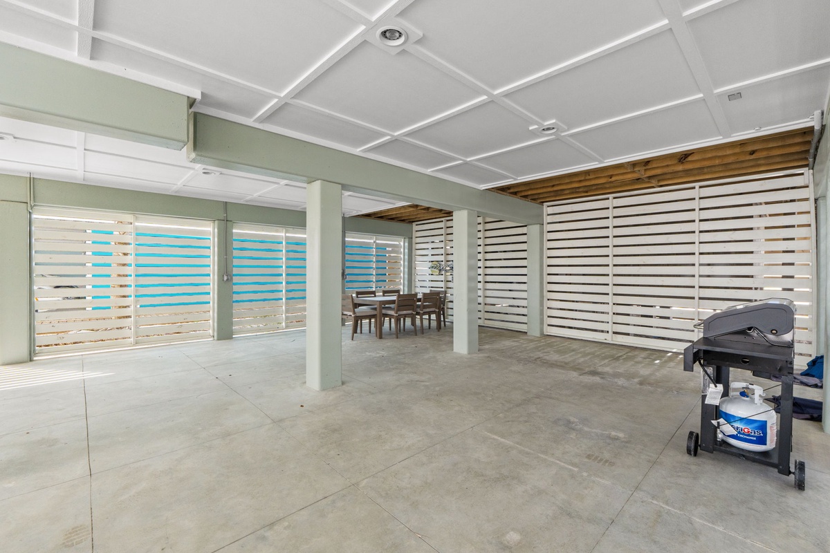 Expansive shaded patio with coastal views and outdoor dining area, perfect for grilling and al fresco meals with your group.