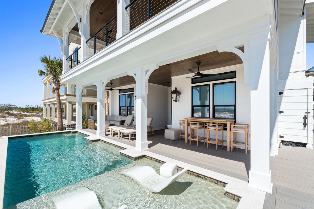 Your private poolside retreat with elegant arches frames sparkling waters and coastal views, perfect for morning coffee or evening cocktails.